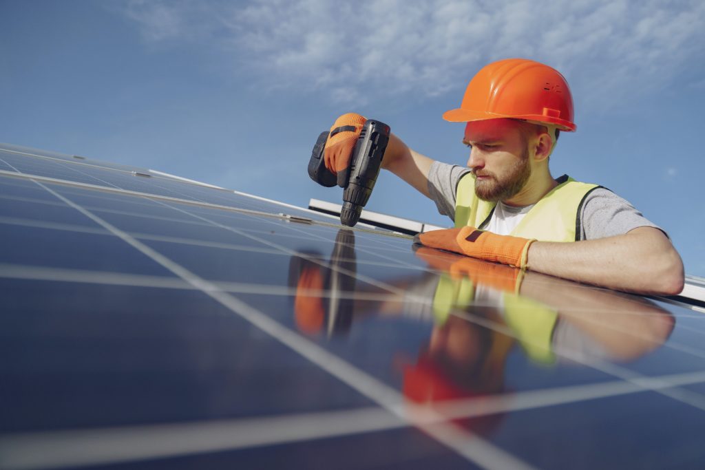 Solar technician installing solar panels