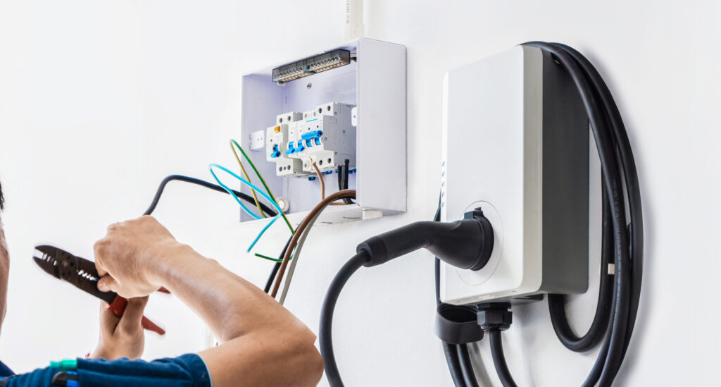 Certified male Electrician Installing Home EV Charger